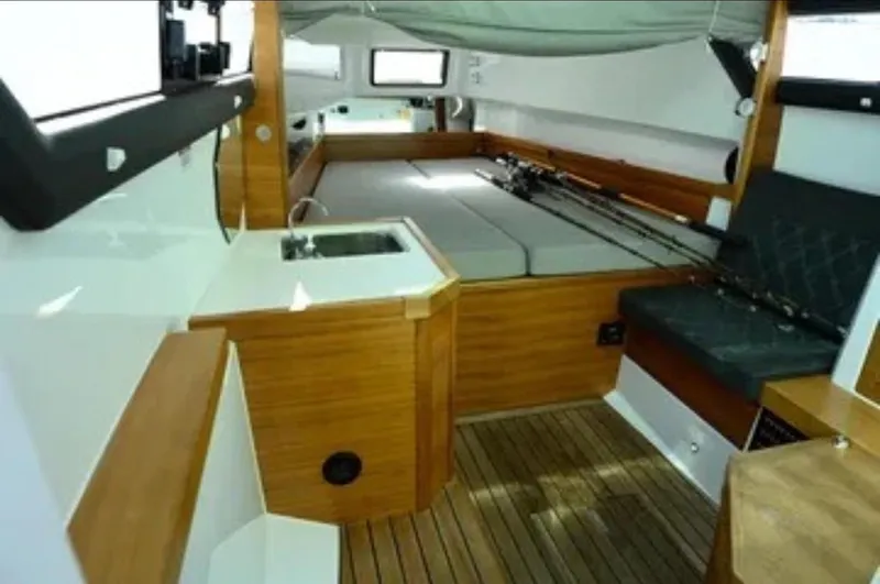 Problem Child Yacht Photos Pics 2017 Axopar 37 Cross Cabin interior with wood finish and seating area.