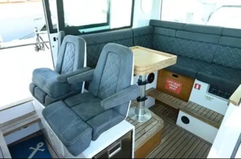 Problem Child Yacht Photos Pics Interior of 2017 Axopar 37 Cross Cabin with seating and table.