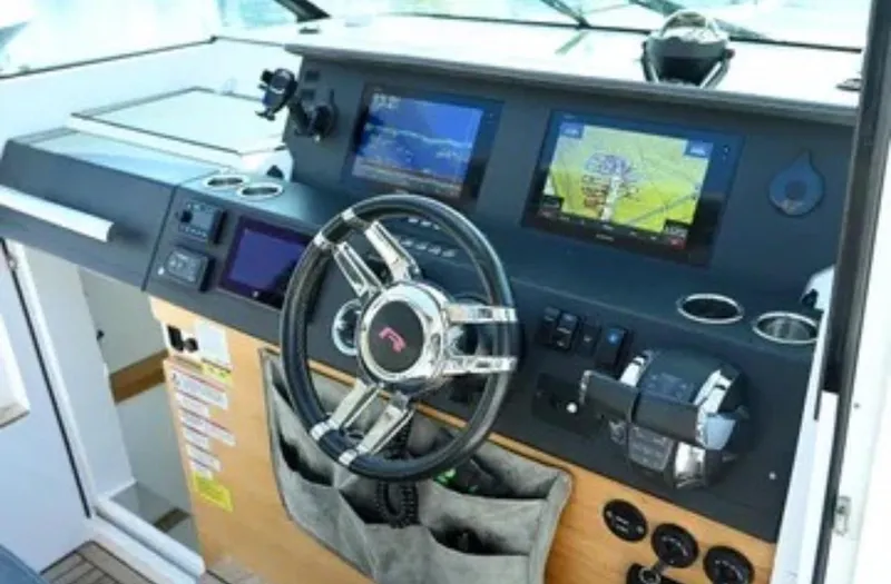 Problem Child Yacht Photos Pics 2017 Axopar 37 Cross Cabin helm with modern navigation displays and controls.