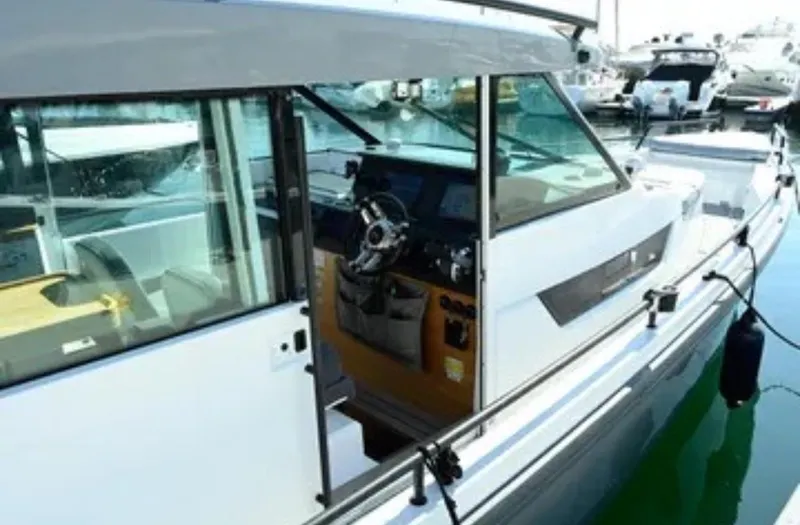 Problem Child Yacht Photos Pics 2017 Axopar 37 Cross Cabin boat interior at marina, showcasing helm and seating area.