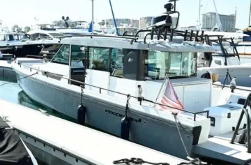 Problem Child Yacht Photos Pics 2017 Axopar 37 Cross Cabin boat docked in a marina, featuring sleek design and modern amenities.