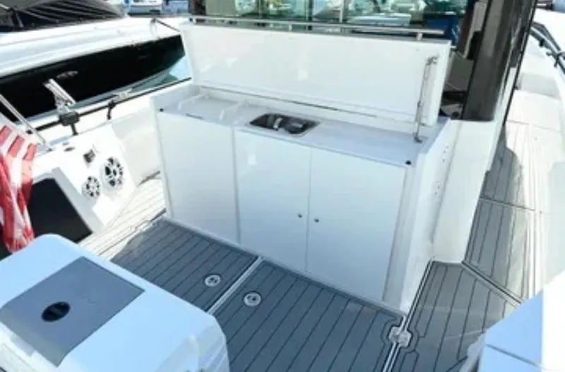 Problem Child Yacht Photos Pics 2017 Axopar 37 Cross Cabin boat deck with outdoor sink and storage.