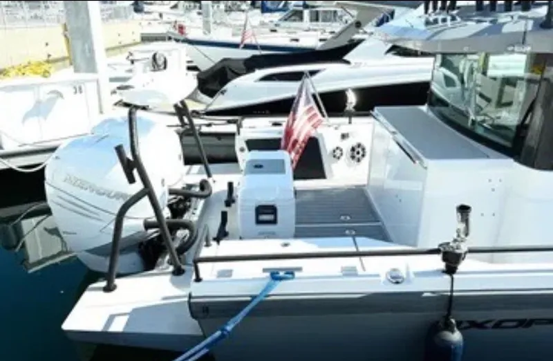 Problem Child Yacht Photos Pics 2017 Axopar 37 Cross Cabin boat docked with American flag and outboard motor.