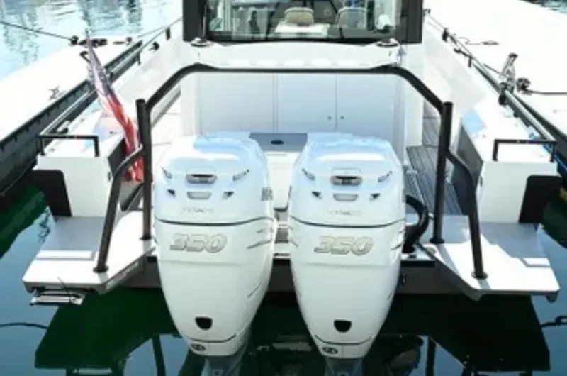 Problem Child Yacht Photos Pics 2017 Axopar 37 Cross Cabin with twin 350 horsepower engines, docked on calm water.