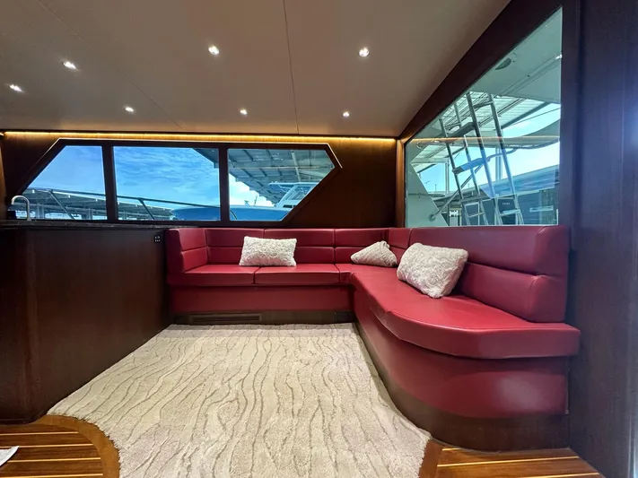 The Godfather Yacht Photos Pics Luxurious interior of 1986 Hatteras 52 Convertible yacht with red leather seating.