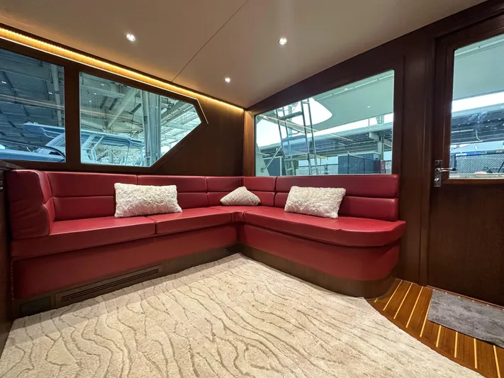 The Godfather Yacht Photos Pics Luxurious interior of 1986 Hatteras 52 Convertible yacht with red leather seating.