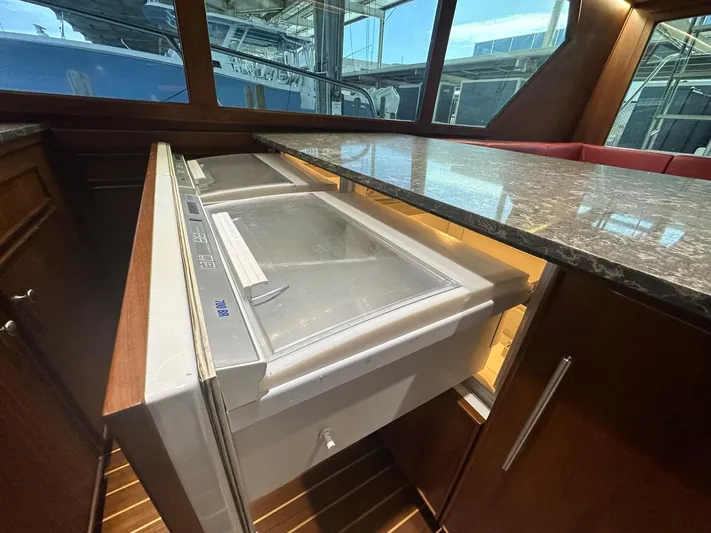 The Godfather Yacht Photos Pics 1986 Hatteras 52 Convertible yacht interior with open freezer drawer and marble countertop.
