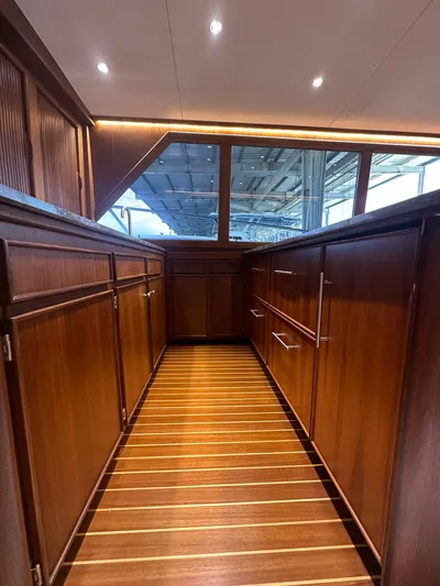 The Godfather Yacht Photos Pics Interior of 1986 Hatteras 52 Convertible yacht with wooden cabinetry and flooring.