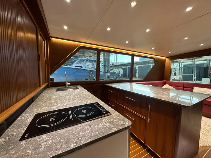 The Godfather Yacht Photos Pics Luxurious interior of 1986 Hatteras 52 Convertible yacht with modern kitchen and seating area.