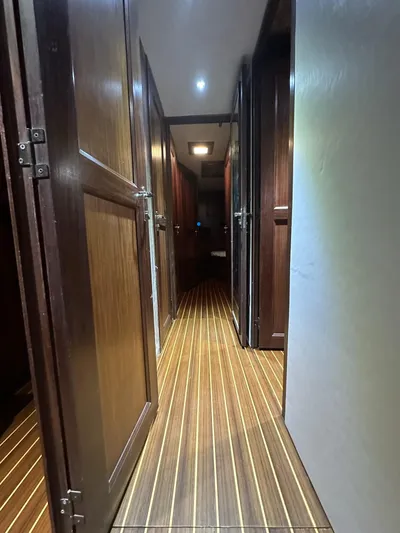 The Godfather Yacht Photos Pics Interior hallway of 1986 Hatteras 52 Convertible yacht with wooden flooring.