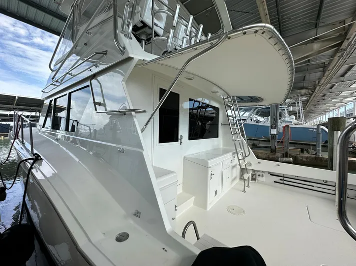 The Godfather Yacht Photos Pics 1986 Hatteras 52 Convertible yacht docked under a covered marina.