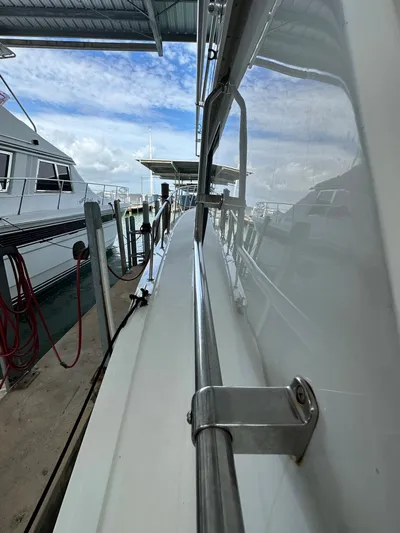 The Godfather Yacht Photos Pics 1986 Hatteras 52 Convertible yacht docked at marina, side view.