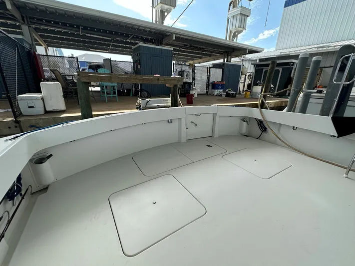 The Godfather Yacht Photos Pics 1986 Hatteras 52 Convertible boat deck in a marina setting.