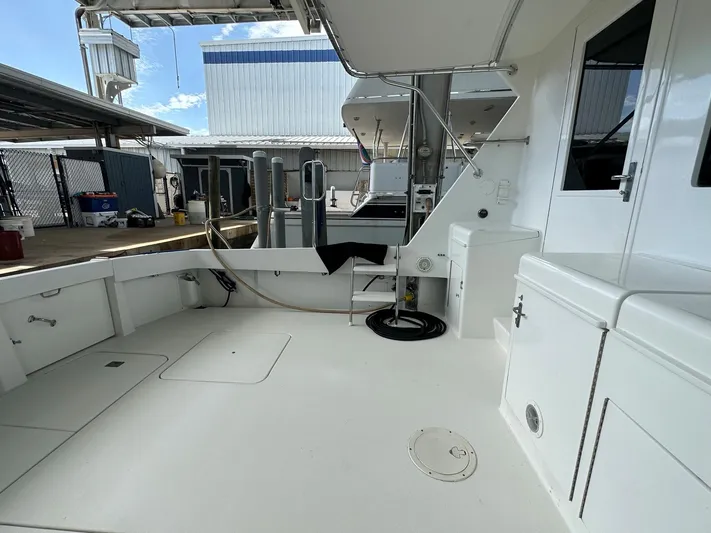 The Godfather Yacht Photos Pics 1986 Hatteras 52 Convertible yacht deck, spacious and well-maintained, docked at marina.