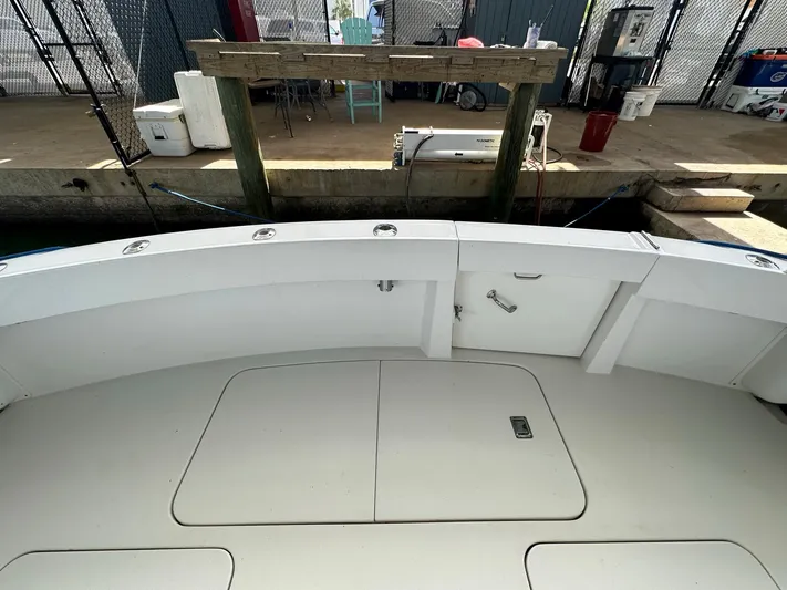 The Godfather Yacht Photos Pics 1986 Hatteras 52 Convertible boat deck at dockside, featuring storage compartments.