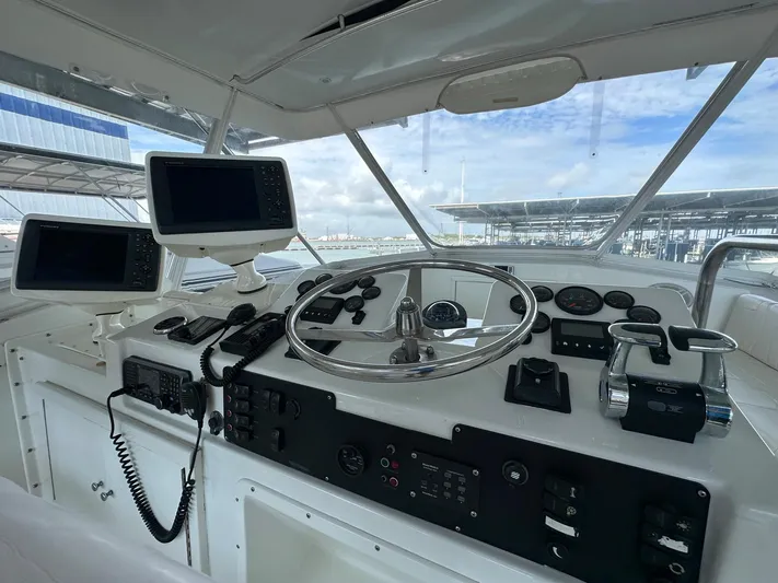 The Godfather Yacht Photos Pics 1986 Hatteras 52 Convertible helm with modern navigation equipment and controls.