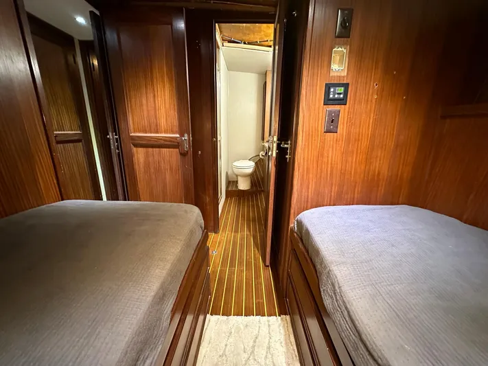 The Godfather Yacht Photos Pics Interior of 1986 Hatteras 52 Convertible yacht with twin beds and wooden finish.
