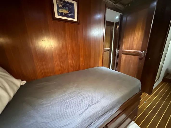 The Godfather Yacht Photos Pics Cozy cabin interior of 1986 Hatteras 52 Convertible yacht with wooden paneling.