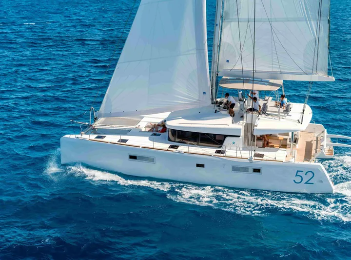 Parlay 2 Yacht Photos Pics 2020 Lagoon 52 F catamaran sailing on clear blue ocean waters.