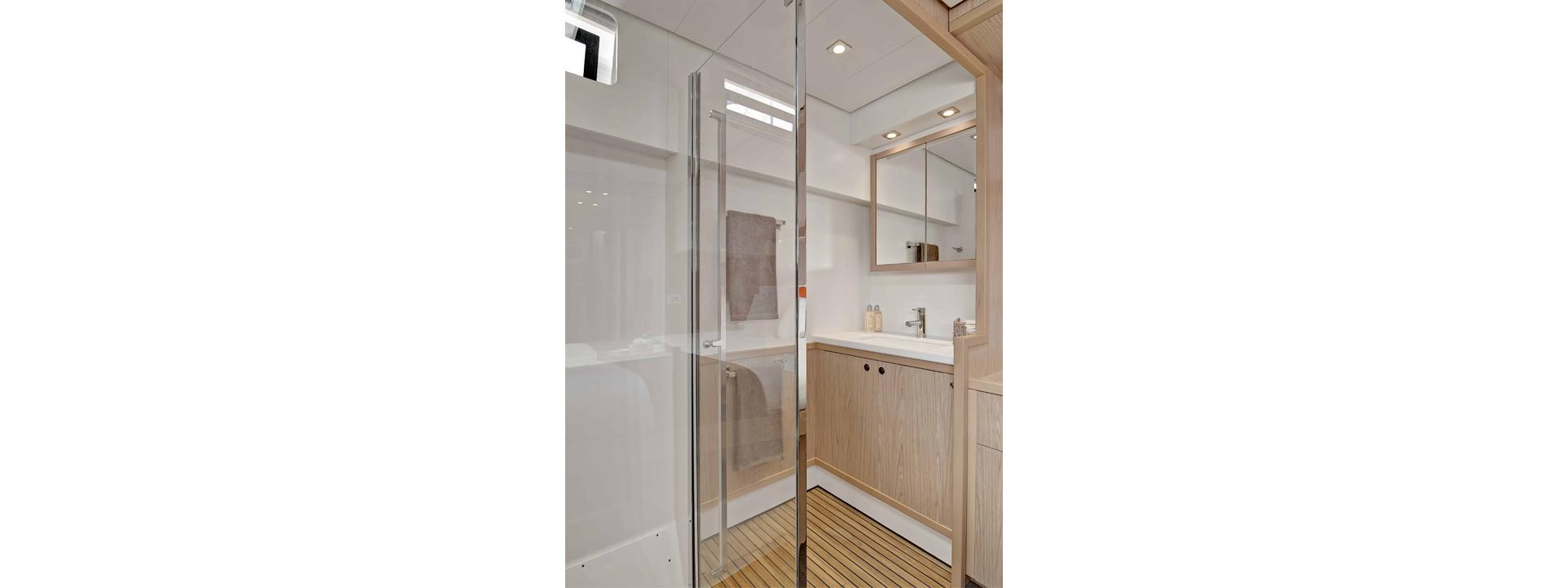 Modern bathroom interior on 2020 Lagoon 52 F yacht, featuring sleek design and wooden accents.