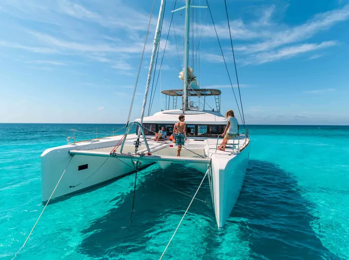 Parlay 2 Yacht Photos Pics 2020 Lagoon 52 F catamaran sailing on clear turquoise waters under a bright blue sky.