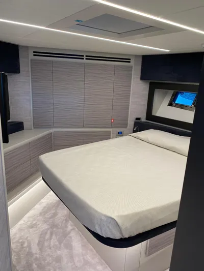  Yacht Photos Pics Luxurious bedroom interior of 2023 Pershing 6X yacht with modern design and ambient lighting.