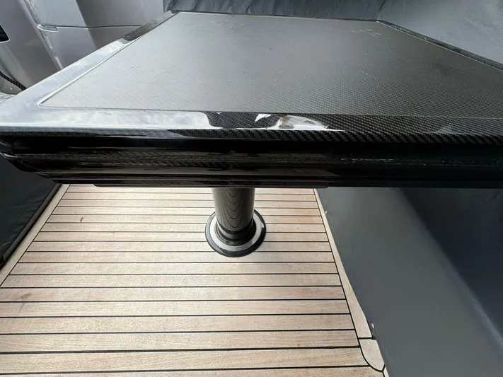  Yacht Photos Pics Carbon fiber table on 2023 Pershing 6X yacht with wooden deck.