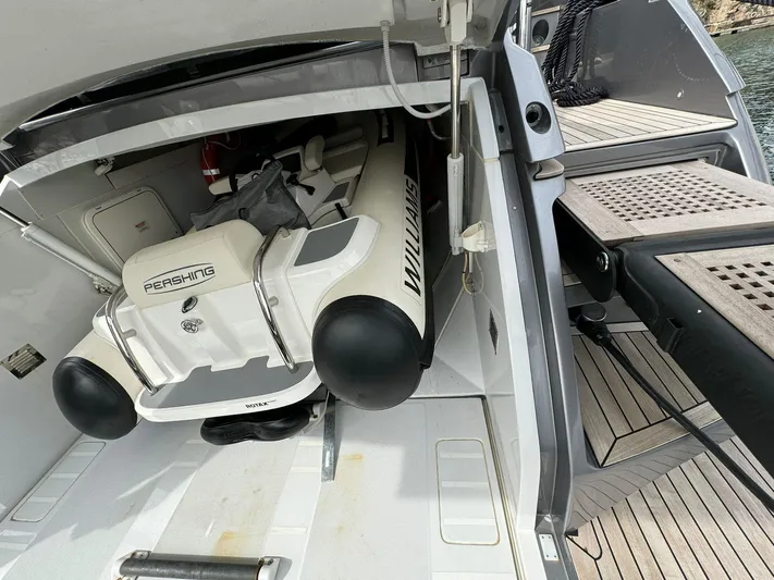  Yacht Photos Pics 2023 Pershing 6X yacht with a stored inflatable boat in the rear compartment.