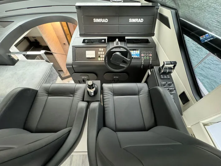  Yacht Photos Pics Cockpit of 2023 Pershing 6X yacht with Simrad navigation system and luxurious seating.