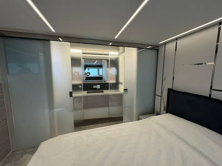  Yacht Photos Pics Luxurious interior of 2023 Pershing 6X yacht with modern bedroom and sleek bathroom design.