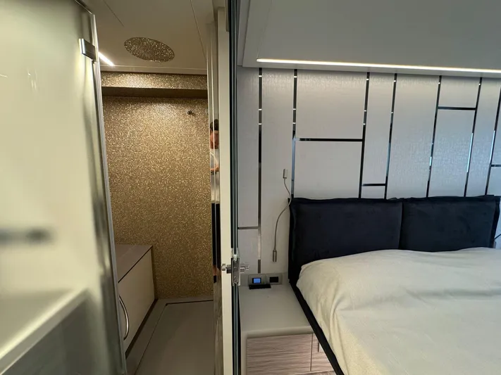  Yacht Photos Pics Luxurious interior of 2023 Pershing 6X yacht featuring a modern bedroom and bathroom.