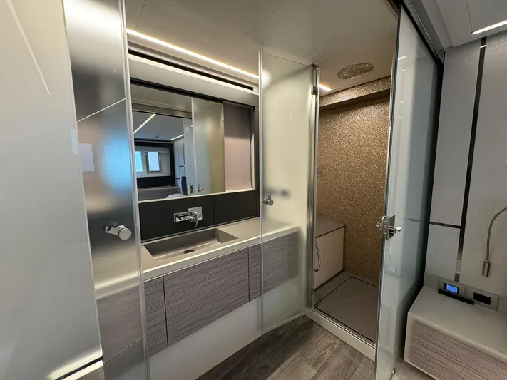  Yacht Photos Pics Luxurious bathroom in 2023 Pershing 6X yacht with modern fixtures and elegant design.