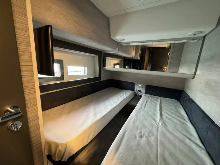  Yacht Photos Pics Interior cabin of 2023 Pershing 6X yacht with twin beds and modern design.