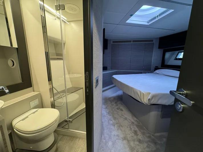  Yacht Photos Pics Luxurious interior of 2023 Pershing 6X yacht featuring a modern bathroom and cozy bedroom.