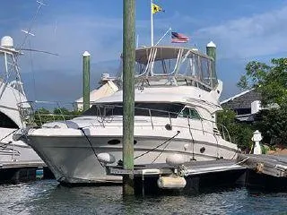  Yacht Photos Pics 2003 Sea Ray 400 Sedan Bridge yacht docked at marina under clear blue sky.