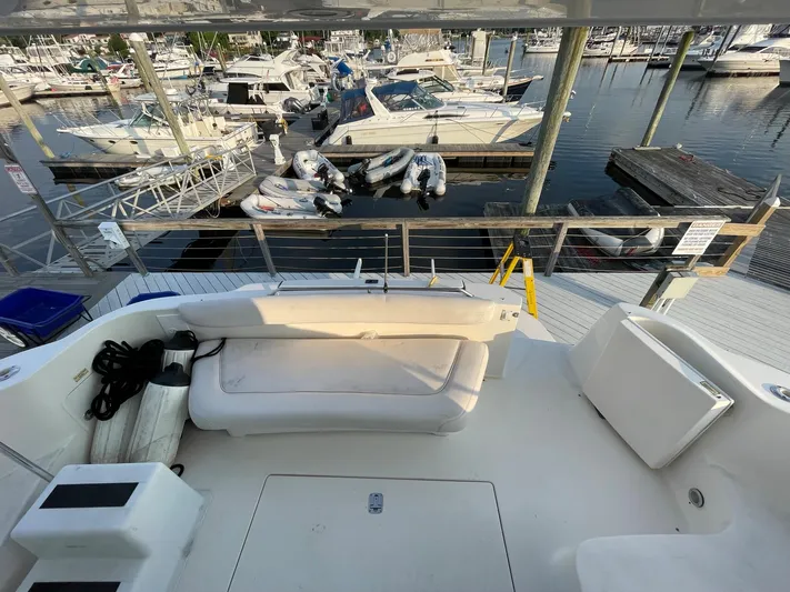  Yacht Photos Pics 2003 Sea Ray 400 Sedan Bridge yacht docked at marina, featuring spacious seating area.