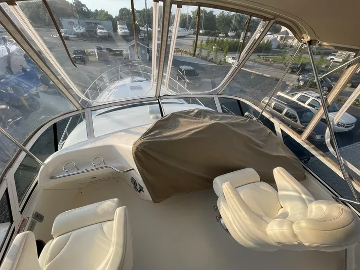  Yacht Photos Pics 2003 Sea Ray 400 Sedan Bridge interior with helm and seating area.