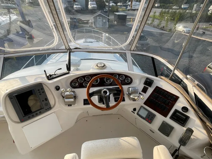  Yacht Photos Pics 2003 Sea Ray 400 Sedan Bridge helm with wooden steering wheel and navigation instruments.