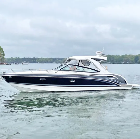  Yacht Photos Pics 2020 Formula 350 Sun Sport boat on a calm lake under cloudy skies.