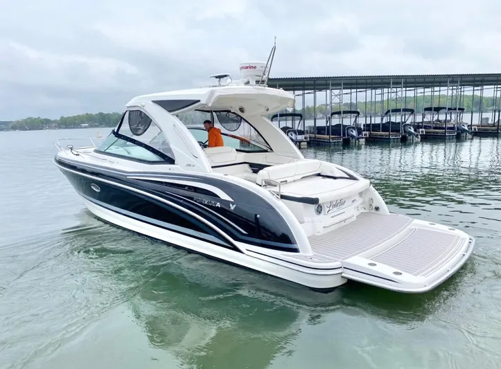  Yacht Photos Pics 2020 Formula 350 Sun Sport boat on calm water near a marina.