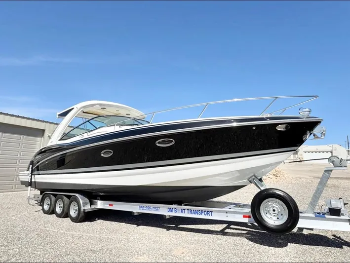  Yacht Photos Pics 2020 Formula 350 Sun Sport boat on trailer, parked outdoors under clear blue sky.