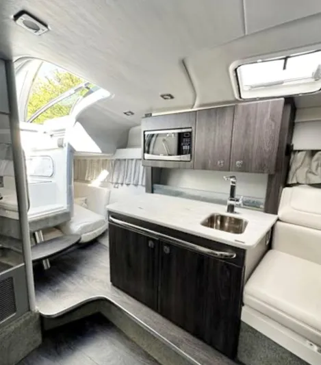  Yacht Photos Pics 2020 Formula 350 Sun Sport interior with kitchenette, microwave, and seating area.