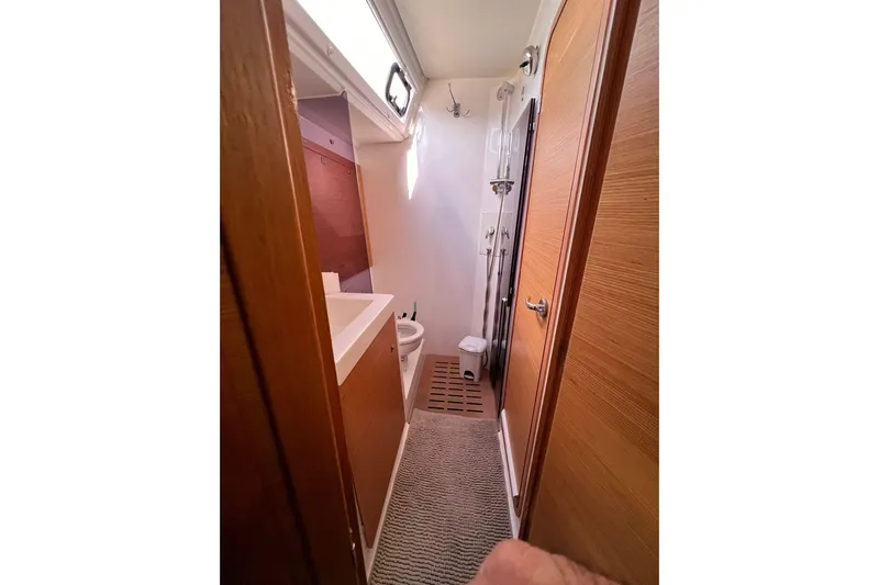  Yacht Photos Pics Bathroom interior of 2017 Dufour 512 Grand Large yacht, featuring modern fixtures and wooden accents.