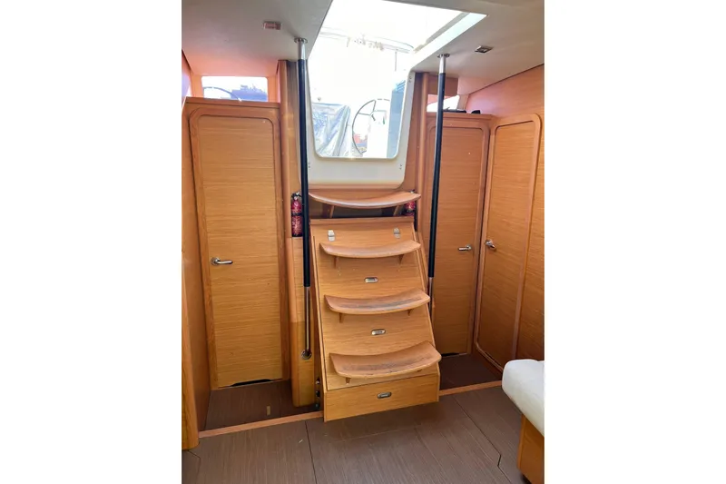  Yacht Photos Pics Interior of 2017 Dufour 512 Grand Large yacht with wooden stairs and doors.