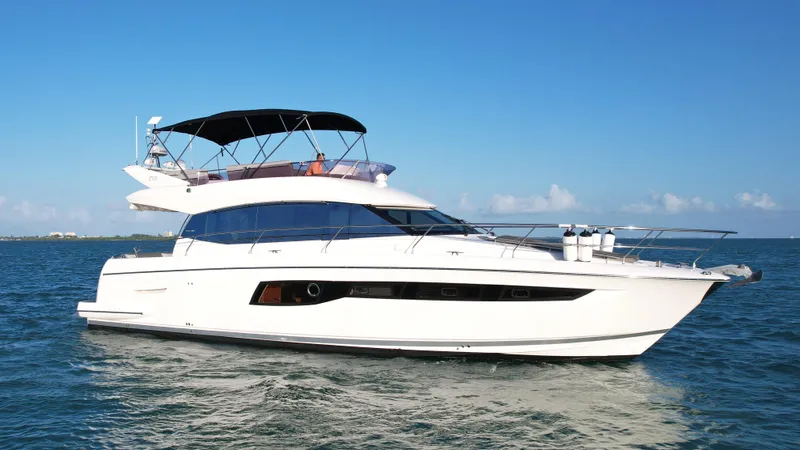 50 Prestige Flybridge Yacht Photos Pics 2014 Prestige 50 Flybridge yacht cruising on open water under clear blue sky.