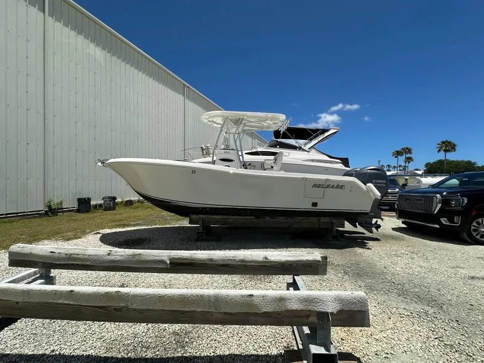 2018 Release 232 RX Center Console boat parked outdoors on gravel near a building.