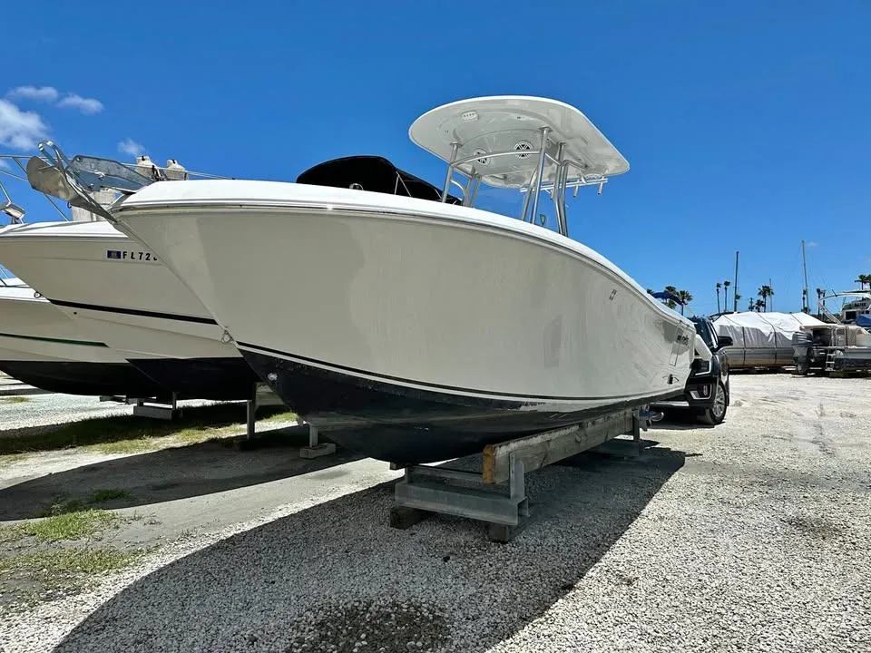 2018 Release 232 RX Center Console boat on display under clear blue sky.