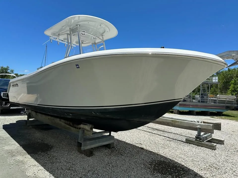2018 Release 232 RX Center Console boat on trailer under clear blue sky.