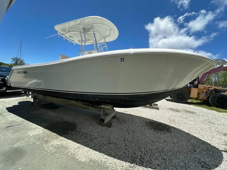 2018 Release 232 RX Center Console boat on display under clear blue sky.