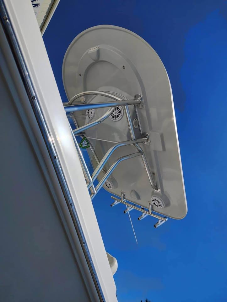 2018 Release 232 RX Center Console boat with T-top against clear blue sky.